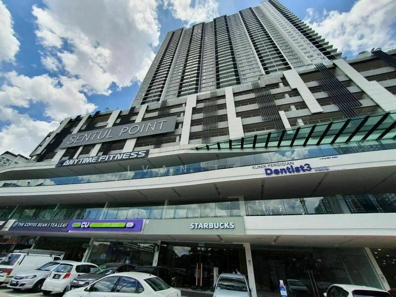 Exterior type: high-rise condominium; features: glass curtain wall, white painted facade, projecting balconies, signage for Starbucks, signage for Anytime Fitness, multiple levels of retail space, open-air parking lot, surrounded by urban environment; style: modern.