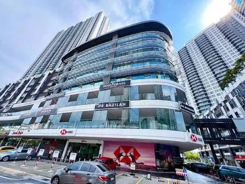 Exterior type: mid-rise condominium; features: glass curtain wall, projecting balconies, white painted facade, signage for businesses, multiple storeys, surrounded by urban landscape, parking area visible, modern architectural design; style: modern.