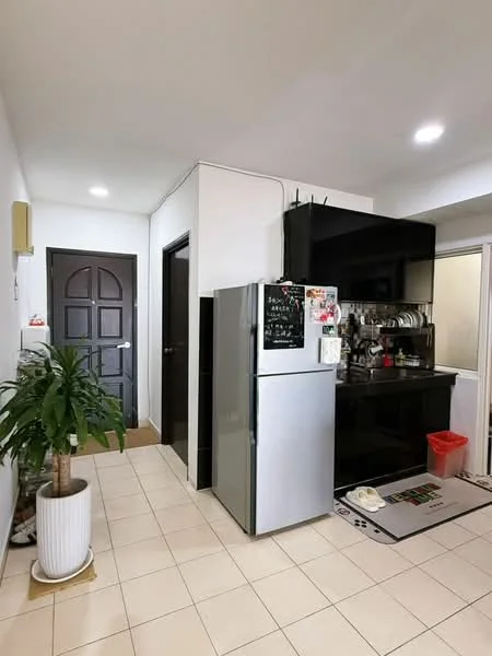 Kitchen features: white painted walls, tile flooring, stainless-steel fridge, black cabinetry, black countertop, sink, kitchen appliances on countertop, recessed downlights, doorway to hallway, indoor plant in pot, rug in front of sink; style: modern.
