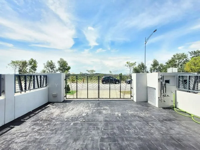 Exterior features: metal gate with decorative pattern, concrete walls, paved driveway, landscaped greenery on both sides, street lighting, open space beyond the gate, visible car parked outside; style: modern.