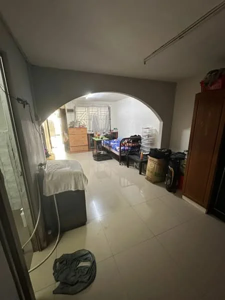 Room features: arched entryway, white painted walls, glossy tile flooring, washing machine, bed with bedding, storage cabinets, plastic storage containers, clothing on the floor.