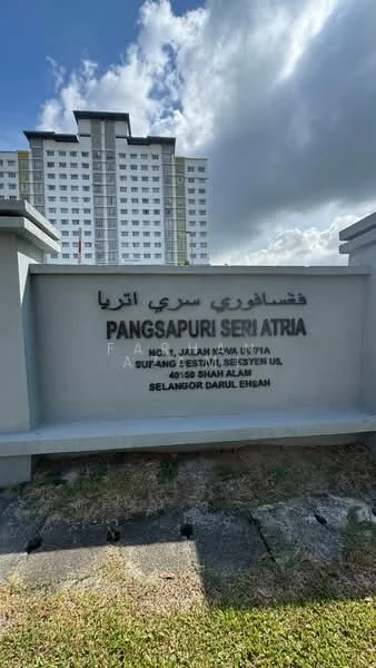 Exterior type: low-rise apartment block; features: white painted facade, signage with building name, manicured lawn, surrounded by greenery, multiple storeys, clear sky, urban setting; style: modern.