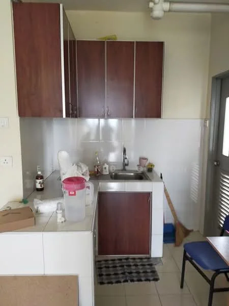 Kitchen features: brown wooden cabinetry, white tiled backsplash, single-bowl stainless-steel sink, chrome pull-down faucet, white countertop, ceramic tile flooring, kitchen towel, cleaning broom, plastic storage container, small bottle of detergent, stool, kitchen mat; style: modern.