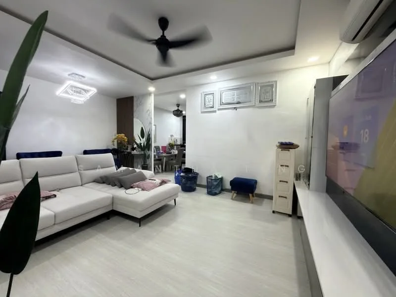 Living features: L-shape sectional sofa in white, ceiling fan with light, wall-mounted TV, TV console, decorative wall paneling, light-colored flooring, recessed lighting, decorative ceiling light, potted plant, blue ottoman, open layout to dining area; style: modern.