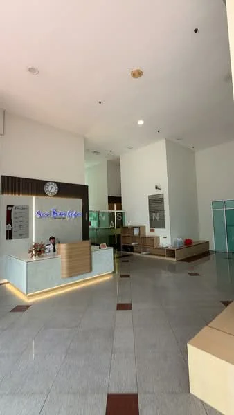 Room features: reception desk with backlit signage, clock on wall, tiled flooring with contrasting patterns, large open space, glass partition, seating area with benches, white painted walls, high ceiling with recessed lighting; style: modern.