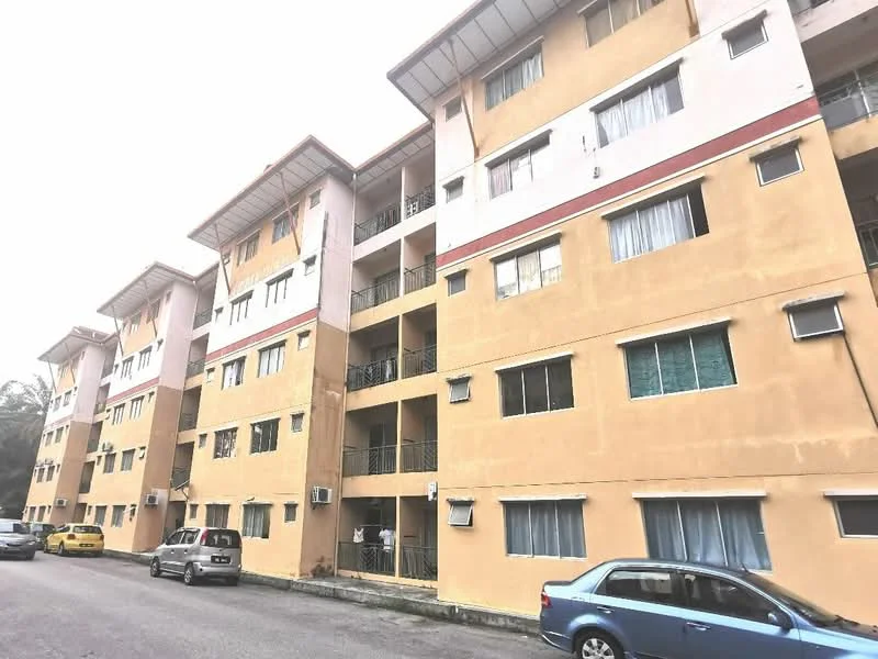 Exterior type: low-rise apartment block; features: cream painted facade, balconies with metal railings, multiple storeys, visible air conditioning units, parking spaces in front, surrounded by greenery; style: modern.