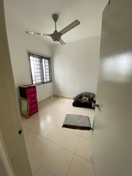 Room features: white painted walls, tiled flooring, ceiling fan, window with metal grille, pink dresser, black cushions or mattress on the floor, area rug, door with handle.
