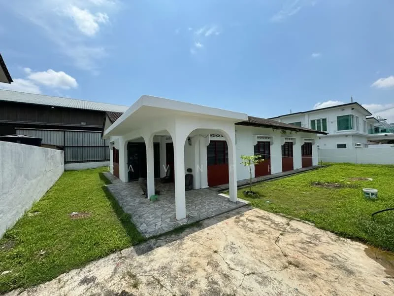 Exterior type: detached bungalow; features: white painted facade, red accent walls, flat roof, single-storey, manicured lawn, paved walkway, outdoor seating area, surrounded by greenery; style: modern.