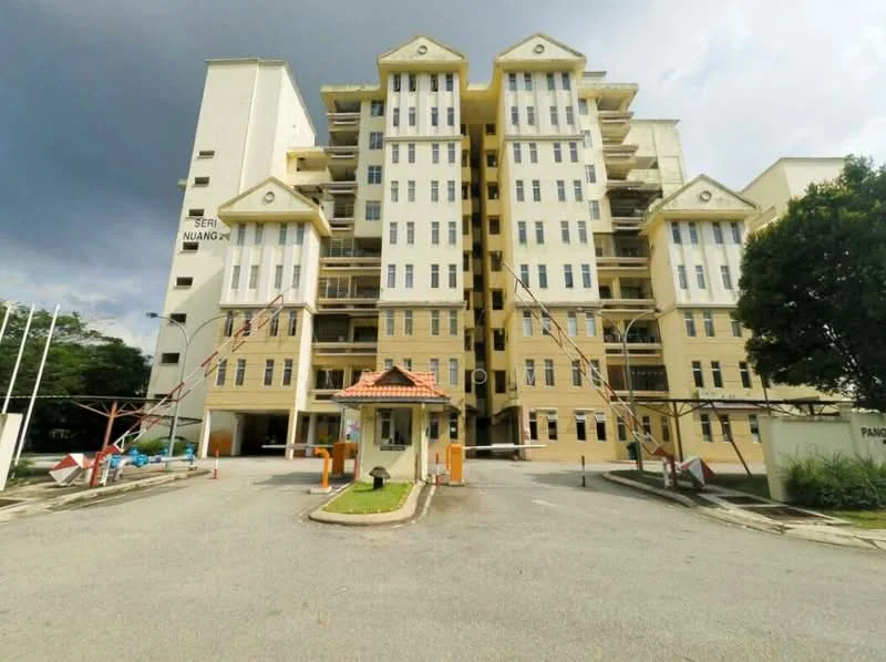 Exterior type: low-rise apartment block; features: cream painted facade, recessed balconies, flat roof, approximately 5-storey, manicured lawn, paved driveway, security boom gate, entrance with canopy, surrounded by greenery; style: modern.