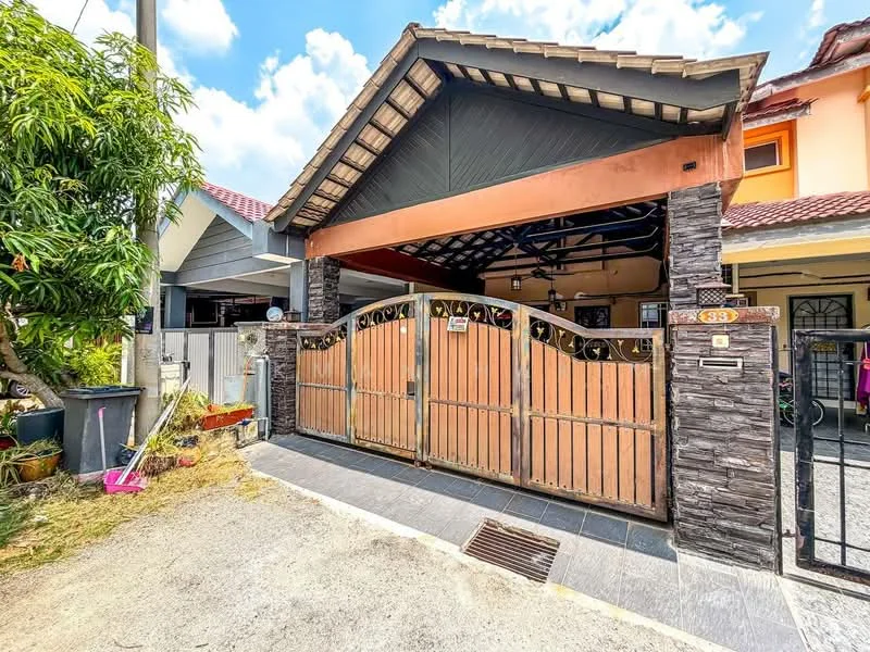 Exterior type: linked terrace house; features: wooden gate, stone cladding on facade, pitched roof, driveway with interlocking pavers, manicured lawn, tropical landscaping, covered car porch, decorative metalwork on gate; style: modern.