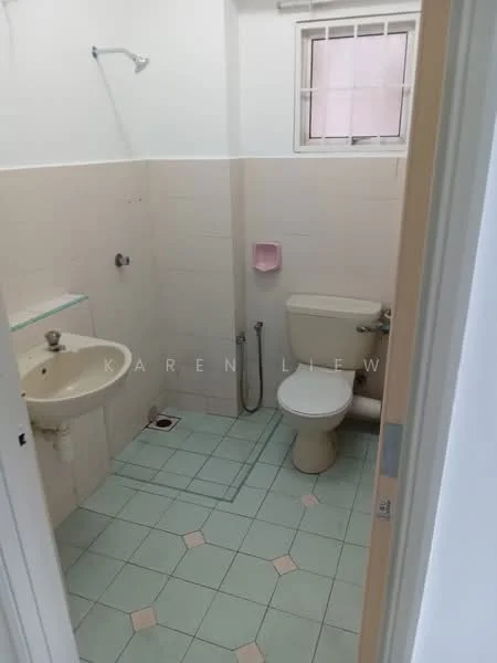 Bathroom features: white tiled walls, light green tiled flooring, single-sink vanity with wall-mounted mirror, toilet, shower with wall-mounted faucet, window with security bars, pink soap holder, drain in floor.