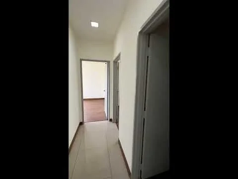 Hallway features: white painted walls, tile flooring, recessed ceiling lights, door frames, two doors leading to rooms, neutral color scheme; style: modern.