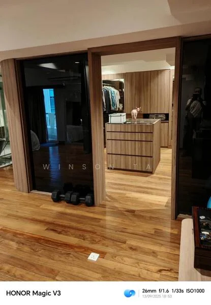 Room features: wooden flooring, built-in wardrobe with sliding doors, chest of drawers, clothing rack, decorative items on surface, dumbbells, neutral wall color, ambient lighting; style: modern.