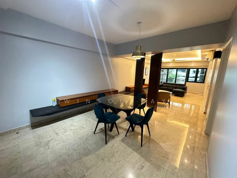 Dining features: marble flooring, white painted walls, ceiling with recessed lighting, dining table with glass top, 4 upholstered dining chairs in blue, wooden bench along the wall, pendant light fixture, open layout to living area; style: modern. Living features: sofa in dark color, coffee table, floor-to-ceiling windows, natural light from windows, open layout to dining area; style: modern.