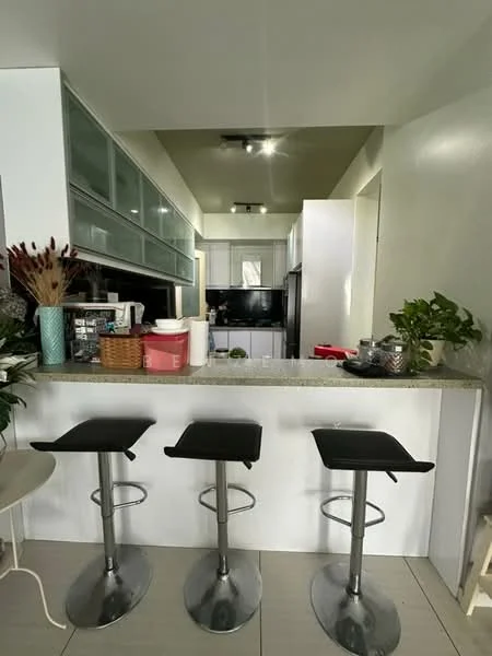 Kitchen features: granite countertop, bar stools with chrome bases, white cabinetry with glass upper cabinets, stainless-steel appliances, black refrigerator, kitchen island, plants in ceramic pots, pendant lighting, open shelving, grey tiled flooring; style: modern.