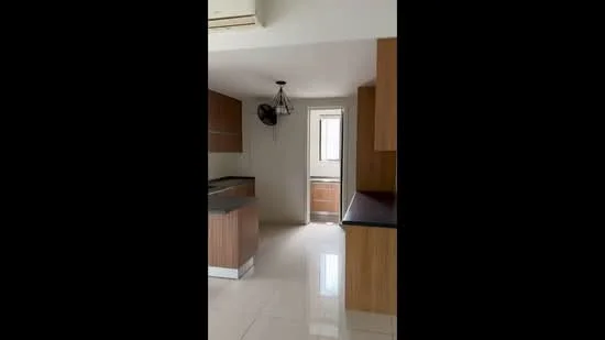 Kitchen features: laminate cabinetry in wood finish, black countertop, single-bowl stainless-steel sink, chrome pull-down faucet, built-in oven, freestanding range oven, wall-mounted split AC, tile flooring, ceiling fan, window with natural light; style: modern.