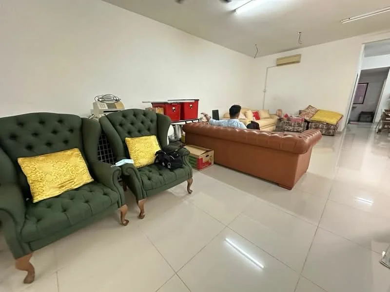 Living features: green upholstered armchairs with wooden legs, brown leather sofa, cream tiled flooring, white painted walls, ceiling-mounted air conditioning unit, decorative cushions on sofa, wooden coffee table, side table with decorative items, wall-mounted lighting, open layout to adjacent dining area; style: contemporary.
