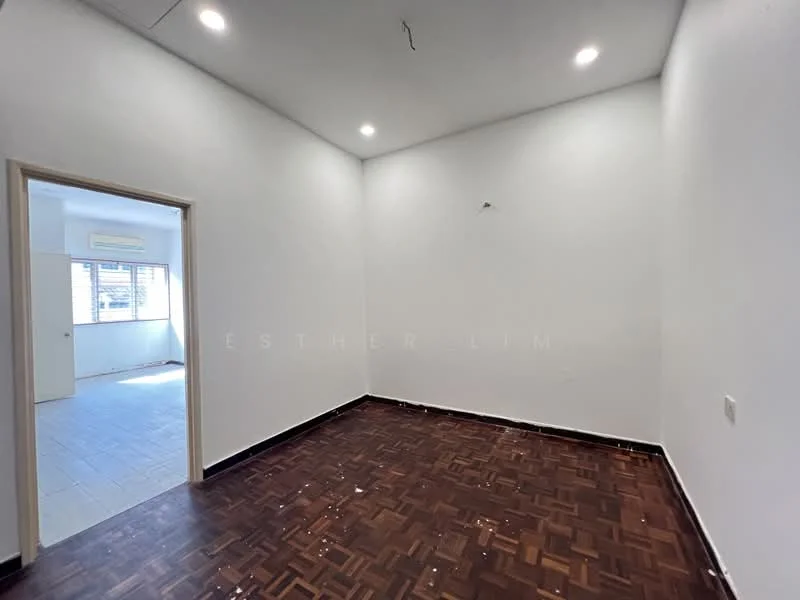 Room features: white painted walls, parquet wood flooring, recessed downlights, corner window, doorway leading to another room.