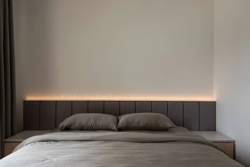 Bedroom features: king-size bed with upholstered headboard, neutral bedding in grey, wall-mounted LED strip lighting above headboard, plain white walls, floor-to-ceiling curtains in grey, wooden bedside tables, minimalist decor; style: modern.