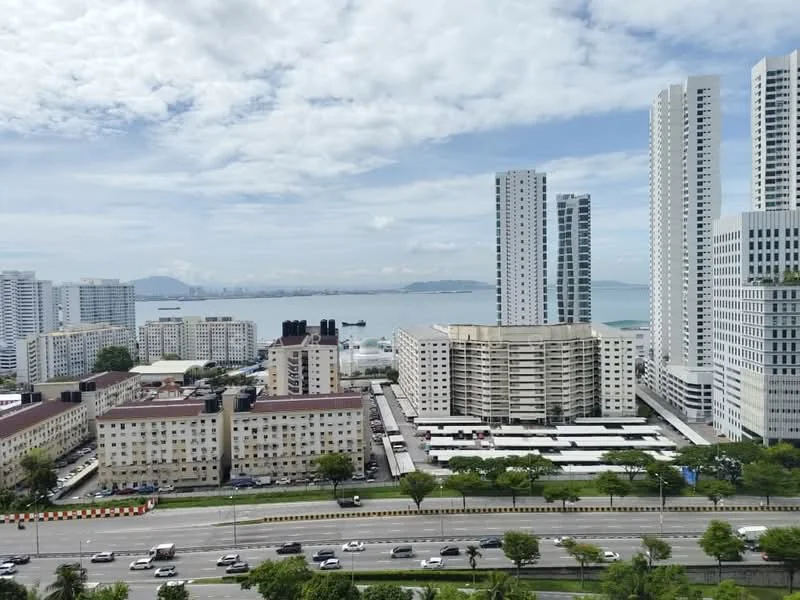 Exterior type: high-rise condominium; features: city skyline view, surrounded by mature greenery, multiple high-rise buildings, waterfront view, open-air parking lot, manicured lawn, modern architectural design; style: modern.
