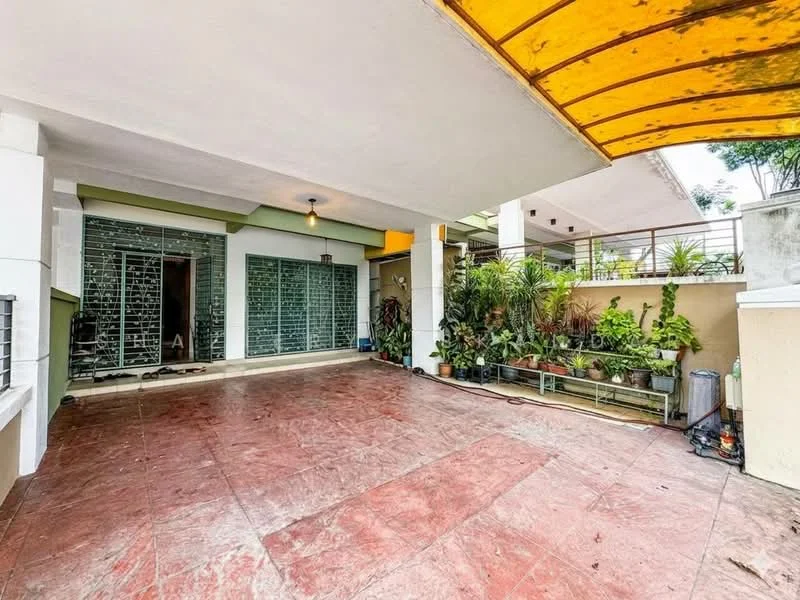 Exterior type: detached bungalow; features: covered porch with yellow awning, exposed concrete walls, red tiled flooring, landscaped garden with plants, glass sliding doors, outdoor space with potential for seating, surrounding greenery; style: modern.