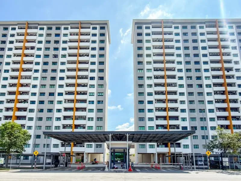 Exterior type: mid-rise condominium; features: two symmetrical towers, grey painted facade, orange accent columns, balconies on each floor, flat roof, covered entrance with awning, landscaped area with trees, parking area in front, multiple windows on each floor, visible entrance lobby; style: modern.