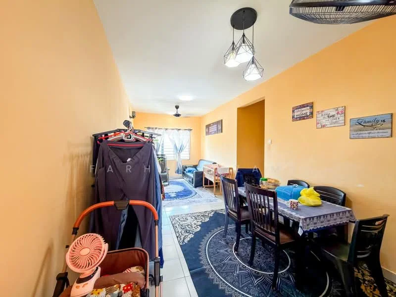 Dining features: orange painted walls, white tiled flooring, ceiling fan with light, dining table with chairs, area rug with geometric pattern, sofa in blue, sofa in grey, window with sheer curtains, clothes rack, stroller, decorative wall signs; style: modern.