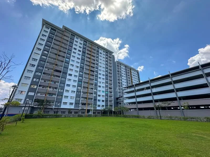 Exterior type: high-rise condominium; features: grey and white painted facade, approximately 10-storey high-rise, balconies on upper floors, manicured lawn, surrounded by greenery, multi-storey car park, clear blue sky, sunlight streaming through clouds; style: modern.