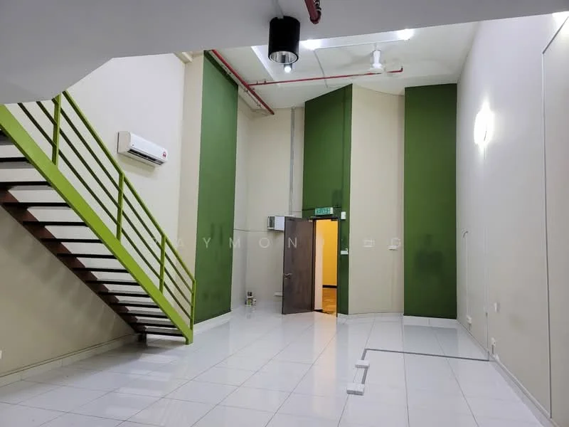 Room features: white tiled flooring, green accent walls, exposed ceiling with ductwork, 1 wall-mounted split AC, staircase with wooden steps and metal railing, recessed LED downlights, doorway leading to another room, light switch on wall; style: modern.