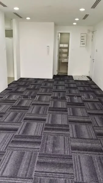 Room features: grey carpet flooring with patterned design, white painted walls, recessed downlights, doorway leading to another room, wall-mounted intercom, air conditioning vent, multiple ceiling lights; style: modern.