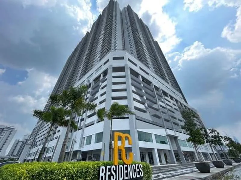 Exterior type: high-rise condominium; features: glass curtain wall, white painted facade, recessed balconies, multiple storeys, landscaped entrance, signage with 'RC RESIDENCES', surrounded by greenery, paved walkway; style: modern.