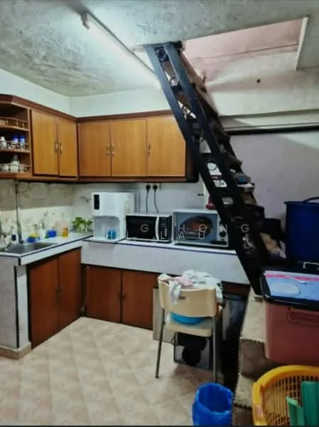 Kitchen features: brown wooden cabinetry, white countertop, single-bowl stainless-steel sink, chrome pull-down faucet, built-in microwave, freestanding range oven, white ceramic tile backsplash, kitchen table with chairs, staircase leading to upper level, tile flooring in beige, exposed concrete ceiling, overhead fluorescent lighting.