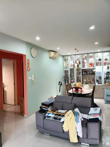Living features: grey fabric sofa, white walls, light grey accent wall, recessed LED downlights, dining table with chairs, display cabinet with glass doors, air conditioning unit, clock on wall, white tiled flooring, decorative items on display, folded clothes on sofa; style: modern. Room features: doorway leading to another room, light switch.