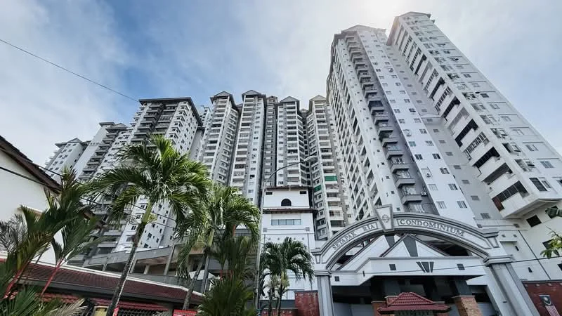 Exterior type: high-rise condominium; features: glass curtain wall, white painted facade, multiple balconies, elevated entrance, landscaped garden in foreground, palm trees, modern architectural design, approximately 20-storey high-rise; style: modern.