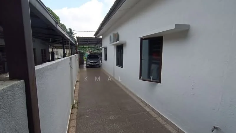 Exterior type: detached bungalow; features: white painted facade, single-storey, paved walkway, windows with black frames, wall-mounted split AC unit, car porch, surrounded by greenery; style: modern.