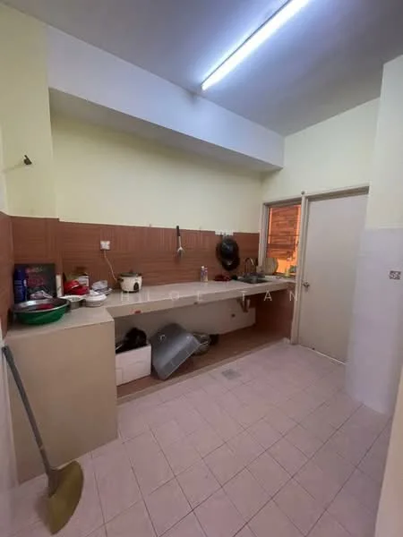 Kitchen features: light yellow painted walls, brown tiled backsplash, white countertop, single-bowl stainless-steel sink, chrome faucet, built-in cabinetry, ceramic tile flooring, overhead fluorescent lighting, door leading to another room.