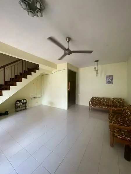 Living features: white painted walls, ceramic tile flooring, 5-blade ceiling fan, staircase with wooden railing, two wooden sofas with floral upholstery, wall-mounted light fixtures, open layout, no visible decor; style: minimalist.