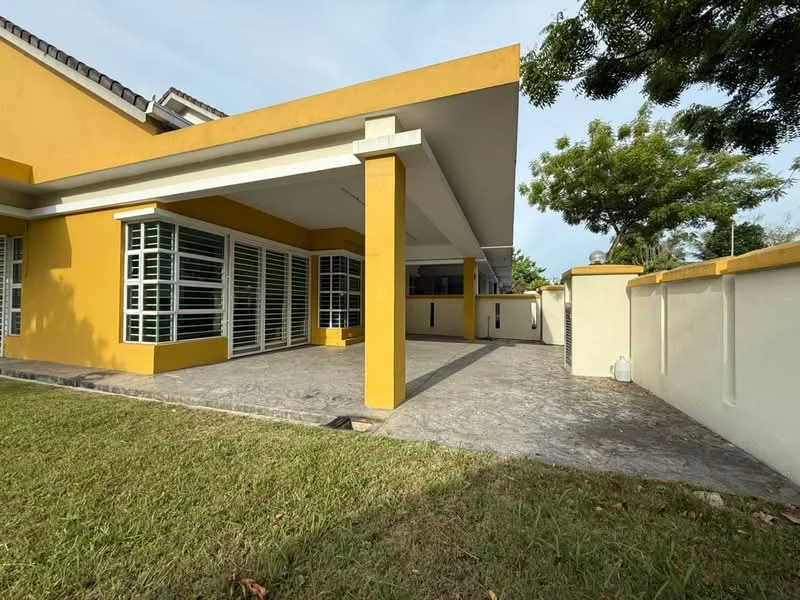 Exterior type: detached bungalow; features: yellow painted facade, flat roof, covered porch area, large windows with horizontal slats, manicured lawn, paved walkway, surrounded by greenery, fenced perimeter; style: modern.