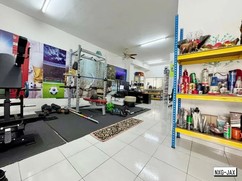 Room features: white painted walls, glossy white tile flooring, ceiling fan, exercise equipment, weight bench, barbell rack, various weights, computer desk, office chair, shelves with assorted items, decorative items on shelves, rug with geometric pattern; style: modern.