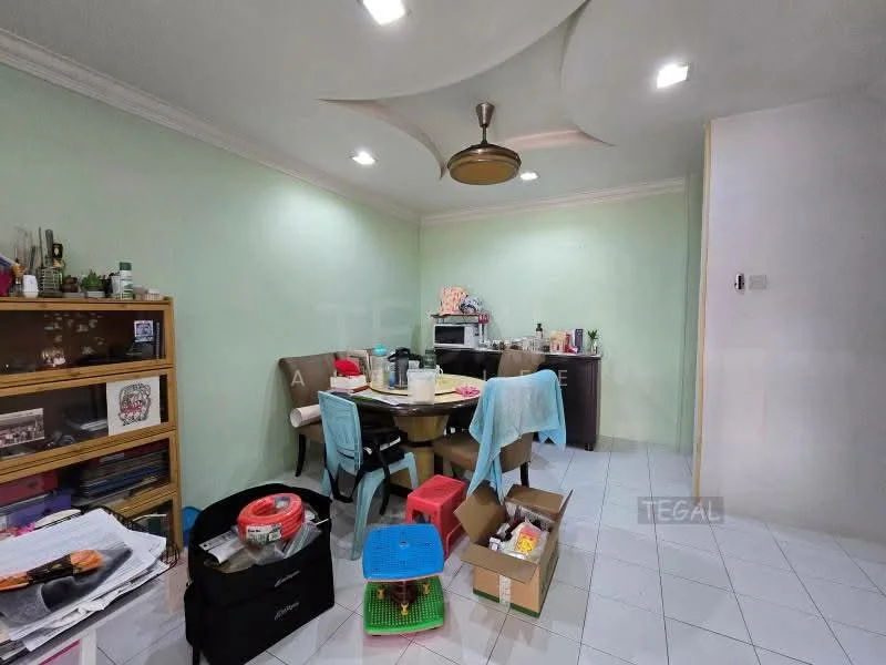 Dining features: green painted walls, white ceiling with crown moulding, 5-blade ceiling fan with light, rectangular dining table, 4 dining chairs, wooden display cabinet, tile flooring, boxes and clutter on the floor.