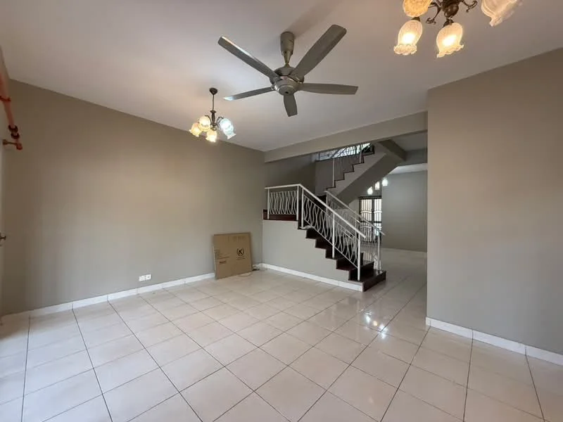 Living features: white painted walls, tile flooring, 5-blade ceiling fan, chandelier with multiple bulbs, staircase with wooden handrail, large window for natural light, empty space for furniture arrangement, box in corner.