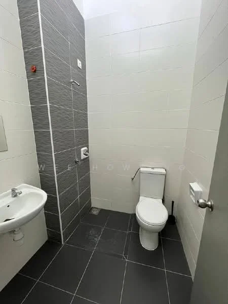 Bathroom features: white toilet, chrome flush handle, single-sink vanity, white sink, grey tiled wall, white tiled wall, grey floor tiles, shower area with wall-mounted faucet, shower head, towel holder, toilet paper holder; style: modern.