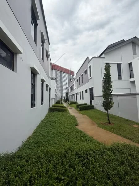 Exterior type: linked terrace house; features: white painted facade, 2-storey buildings, manicured lawn, pathway with interlocking pavers, landscaped greenery, surrounded by mature trees, urban context with high-rise in background; style: modern.