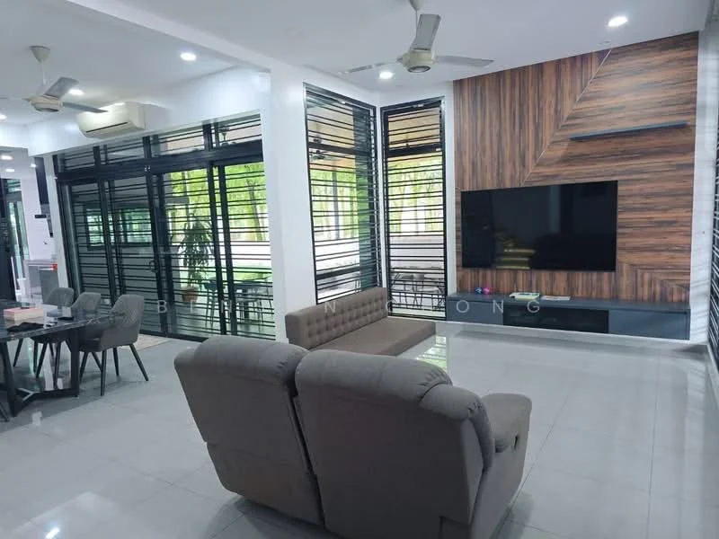 Living features: grey fabric 3-seater sofa, flat-screen TV mounted on wall, wood feature wall, large glass windows, sliding glass doors, recessed ceiling lights, ceiling fan, polished tile flooring, decorative indoor plants, open layout with dining area visible, black media console below TV; style: modern; view: garden.