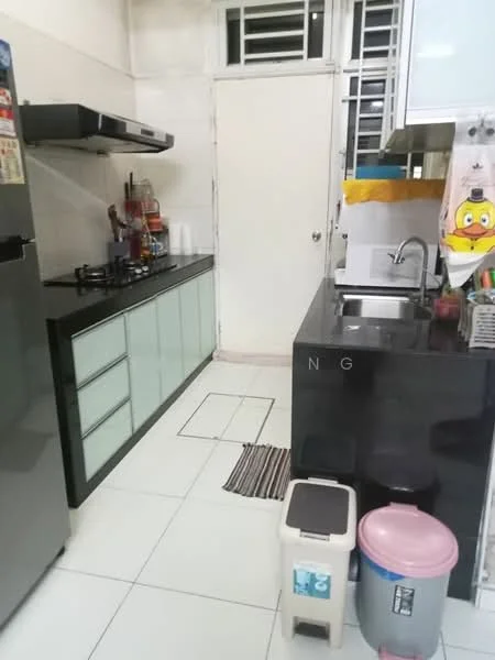 Kitchen features: black granite countertop, stainless-steel sink, chrome pull-down faucet, glass-front cabinetry in green, built-in gas stove, stainless-steel fridge, white tiled walls, white tiled flooring, kitchen towel hanging, plastic trash bin, small stool, decorative items on countertop; style: modern.