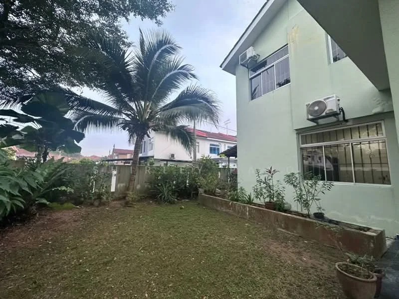 Exterior type: detached bungalow; features: green grass lawn, mature palm tree, landscaped garden with shrubs, exterior wall painted in light green, window-mounted air conditioning unit, fenced garden area, paved walkway, surrounding greenery; style: modern.