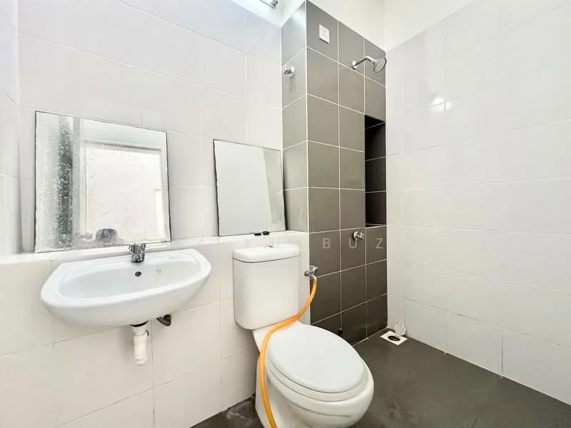 Bathroom features: white tiled walls, grey tiled accent wall, floor-to-ceiling mirror, single-sink vanity with chrome faucet, one-piece toilet, shower area with wall-mounted shower head, grey ceramic flooring, window for natural light; style: modern.