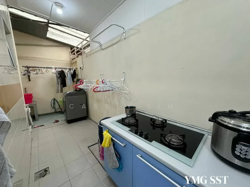 Laundry features: grey tiled flooring, white painted walls, kitchen countertop with blue cabinetry, double-burner gas hob, rice cooker, washing machine, clothes drying rack, sink with faucet, open shelving, window for natural light, hanging clothes line; style: modern.
