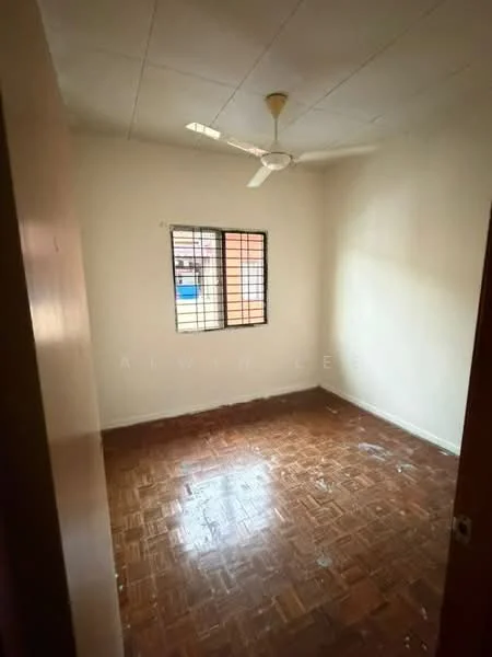 Room features: wooden flooring, white painted walls, ceiling fan, window with metal grille, natural light from window, unfurnished, no visible closet, plain ceiling.