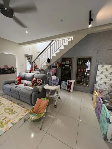 Living features: grey fabric sectional sofa, decorative cushions, area rug with playful design, white tiled flooring, ceiling fan, wall-mounted mirror, staircase with metal railing, decorative shelving unit, baby stroller, baby playpen, wall-mounted decor, curtains, wall with grey accent, light fixtures; style: modern.